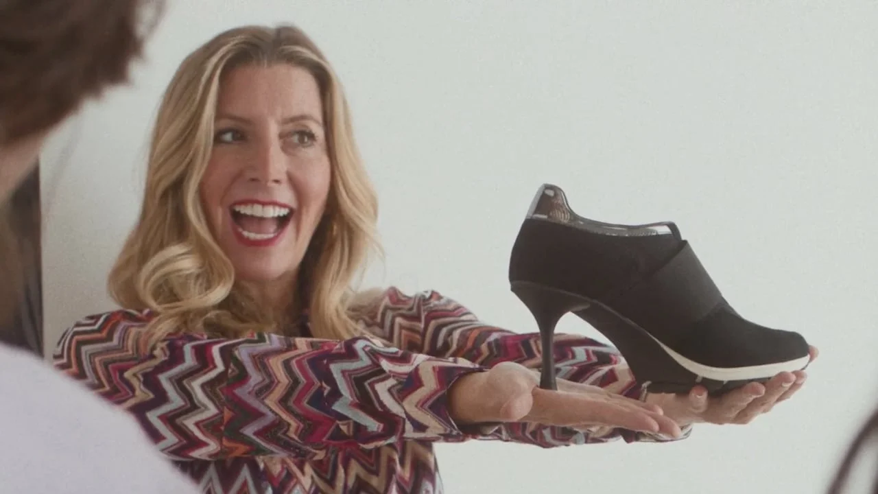 Sara Blakely presenting a Sneex shoe in the brand’s founder video.