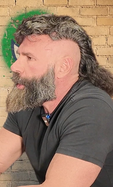 Dan Bilzerian wearing a dark polo shirt during an interview.