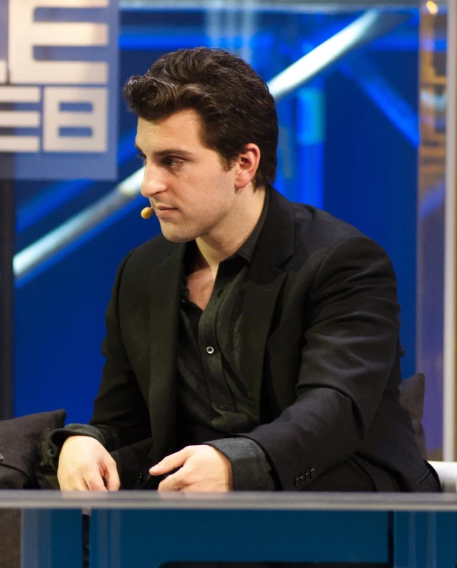 Brian Chesky in a dark jacket and white shirt during a LeWeb interview.